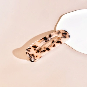 Detail of tortoise shell acetate hair claw clip with white and black mottled pattern