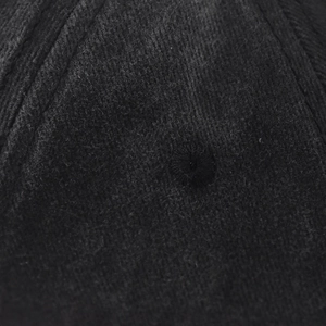 Macro shot of embroidered eyelets and reinforced stitching on a washed baseball cap