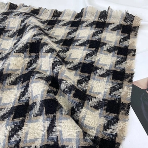 Classic black and white houndstooth scarf with tassels and soft layered texture