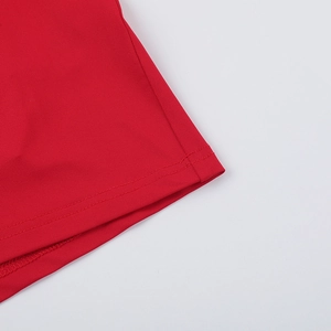 Close-up of high-quality double-needle stitching on a red knitted evening dress