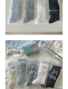 Detail of ballet style knit socks featuring ribbon bows and diverse color palettes