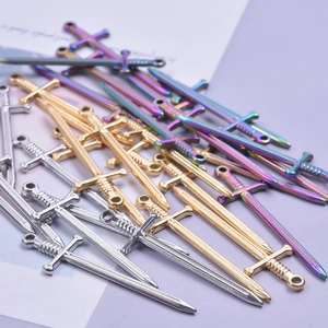 Colorful fencing sword pendants in silver and gold plating on decorative paper