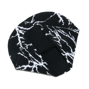 Macro detail of lightning pattern on black knitted beanie showing fabric texture and weave