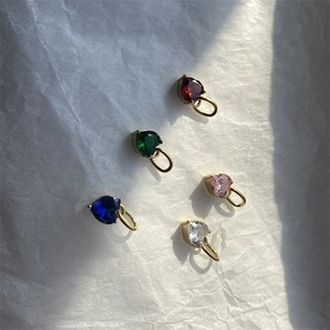 Five colorful heart zircon pendants in 14K gold plated stainless steel on white paper
