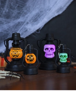 Set of four LED Halloween lanterns featuring glowing pumpkin and skull designs on wood