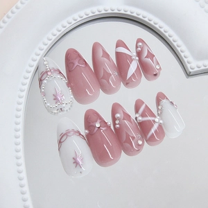 Pink and white gradient press-on nails with pearls, crystals and starbow designs