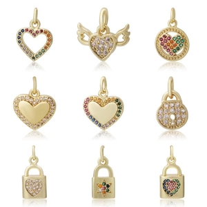 Assorted DIY gold charms with zircon inlays including heart and lock shapes on white background