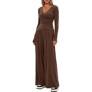 Detail of dark brown knit two-piece set featuring crossover top and wide-leg trousers