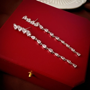 Elegant long silver tassel earrings with teardrop zircons on a luxury red velvet box