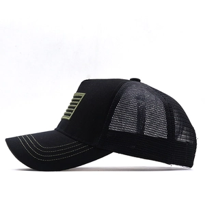 Detail of black trucker cap with breathable mesh and green stitched visor stripes