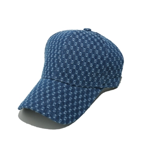 Close-up of textured blue denim baseball cap with distressed details and 6-panel design
