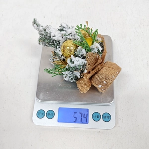 Mini Christmas tree decoration with faux snow and gold bauble weighing 57.4 grams