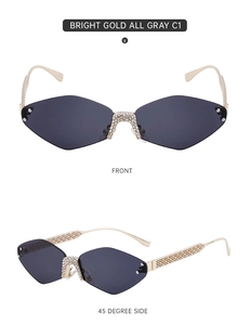 Detail view of rimless diamond sunglasses with bright gold frames and gray gradient lenses