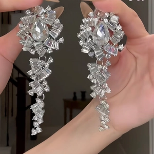 Macro shot of sparkling silver crystal flower drop earrings with a vintage chandelier design