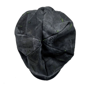 Detailed close-up of distressed knit beanie featuring contrast green hand-stitched seams