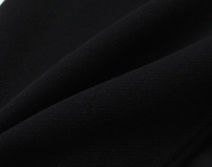 Macro detail of high-quality black woven fabric texture with fine fiber and soft wool-like feel