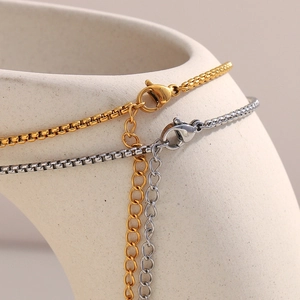 Detail of 18K gold and silver box chains with lobster clasps and extension links