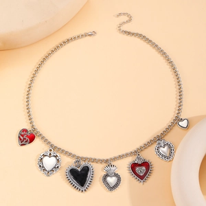 Gothic silver alloy necklace featuring multiple red and black sacred heart pendants