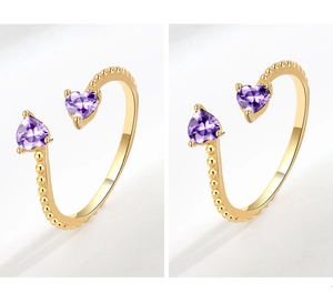 Detail of gold beaded open ring featuring two heart-shaped purple zircon gemstones