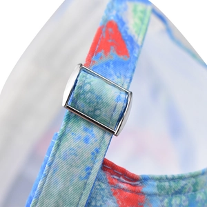Detail of adjustable silver metal buckle and tie-dye fabric on the baseball cap