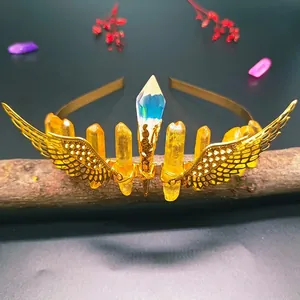Handmade golden crown with wings and colorful raw crystal pillars on a headband