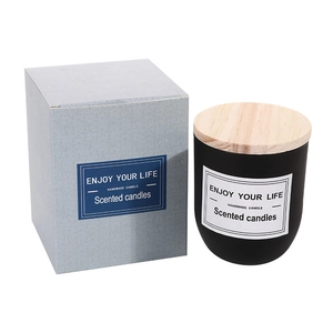 Handmade scented candle in matte black glass jar with wooden lid and gift box packaging