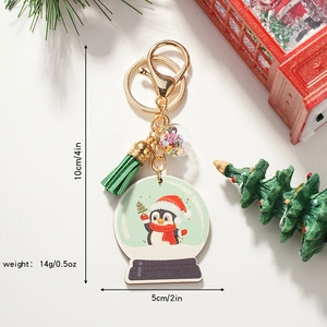 Cute Christmas penguin snow globe keychain with green tassel and gold ring, 10x5cm size
