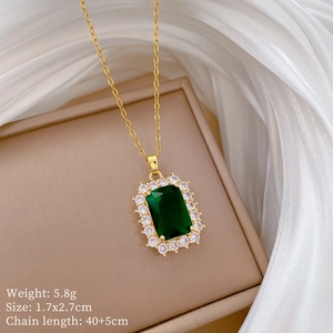 Detailed macro view of a 1.7x2.7cm green emerald pendant with crystal halo on silk
