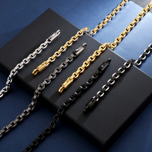 Detail of box chain bracelets in silver, gold, and gun black finishes with large ring clasps
