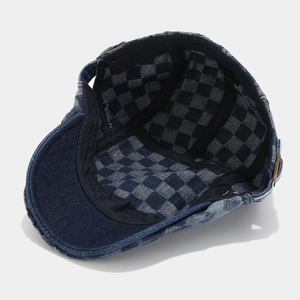Vintage dark blue denim newsboy cap with classic checkered lining and brass adjustment buckle