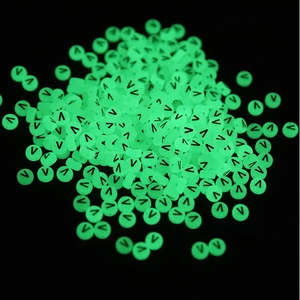 Close-up of 7x4mm luminous green round beads with black letter V for DIY crafts