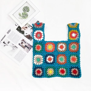 Detailed macro of handmade crochet granny square tote bag with colorful geometric patterns