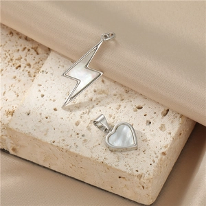 Vintage silver heart and lightning pendants with natural pearl shell inlay on stone