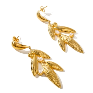 Gold leaf earrings with pearl accents in 18k plated stainless steel on white background