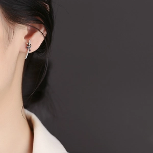 Elegant S925 sterling silver drop earrings with colorful gemstones worn by a model