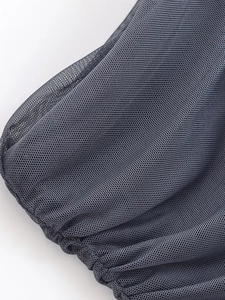 Macro shot of dark grey mesh fabric with ruched details and fine net texture