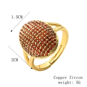 Detail view of 18k gold plated copper ring with micro-pave orange zircon stones