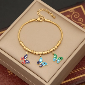 Gold butterfly evil eye charm bracelet with snake chain in a jewelry display box