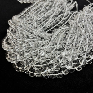 Macro shot of high-clarity natural white crystal round beads for DIY jewelry making