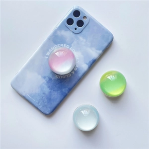 Macro shot of colorful jelly crystal ball collapsible phone grips on a cloud case