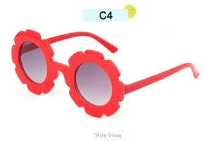 Side view of flower-shaped kids sunglasses with red frames and purple gradient lenses