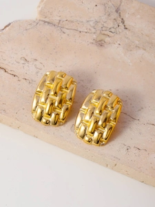 Detail of gold titanium steel earrings with embossed woven texture and rectangular shape