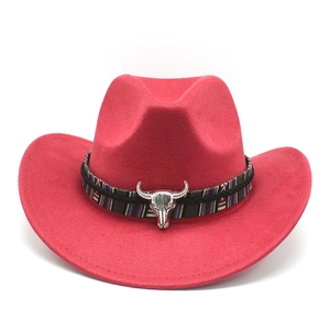 Close-up of red suede cowboy hat featuring a silver bull head metal ornament and braided band