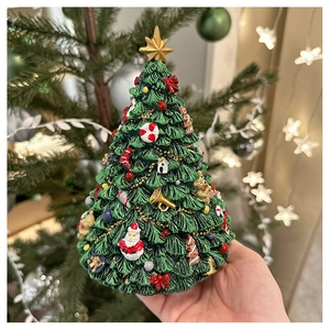 Detail of miniature resin Christmas tree music box with colorful 3D holiday ornaments