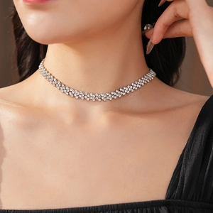 Close-up of layered silver choker necklace with pavé diamond geometric links on model
