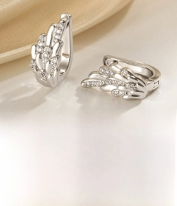 Detail view of silver angel wing earrings with cubic zirconia and size dimensions