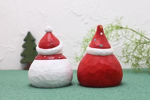Rear view detail of hand-carved wooden Christmas snowman and Santa Claus figurines