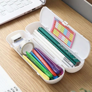 White minimalist dual-layer plastic pencil case on wooden desk with keyboard