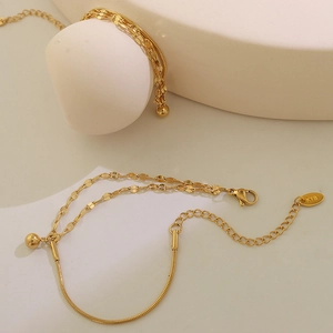 Double-layered gold-plated stainless steel lip chain bracelet with small bead pendant