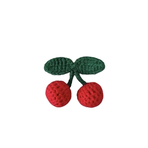 Handmade crochet cherry hair accessory with vibrant red cherries and green leaves